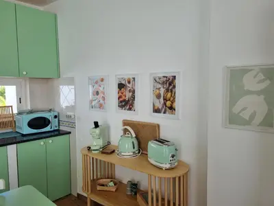 a kitchen with green appliances on a table at Cosy Guest House - Villa das Alfarrobas in Algoz