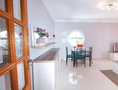 a kitchen and dining room with a table and chairs at Tatiana 1 bedroom apartment in Albufeira