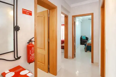 a hallway with a fire extinguisher in a room at Tatiana 1 bedroom apartment in Albufeira