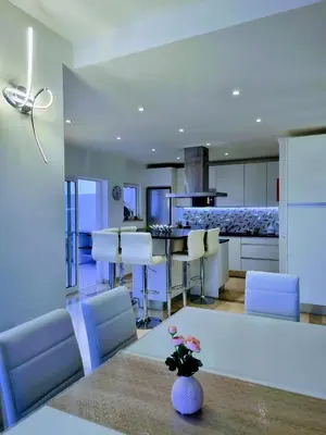 a kitchen and living room with a table and chairs at Penthouse Rentalbufeira in Albufeira