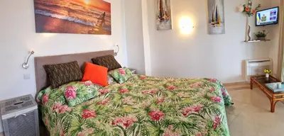 a bedroom with a bed with a colorful comforter at Penthouse Rentalbufeira in Albufeira