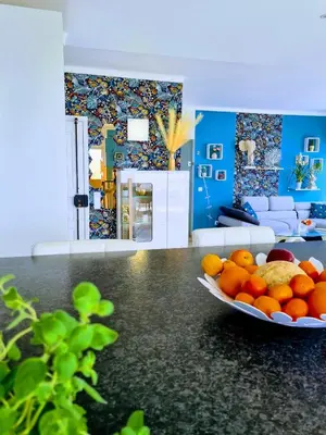 a living room with a bowl of oranges on a counter at Penthouse Rentalbufeira in Albufeira