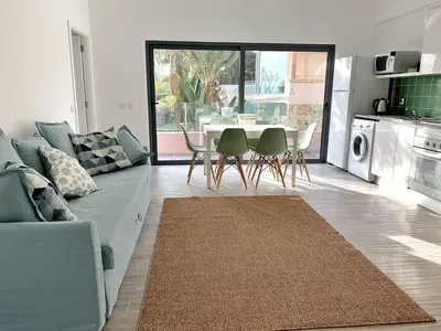 a living room with a couch and a table and chairs at DIANA BEACH HOUSE in Albufeira