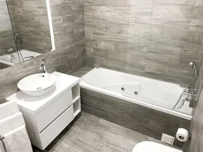 a bathroom with a tub and a sink and a toilet at DIANA BEACH HOUSE in Albufeira