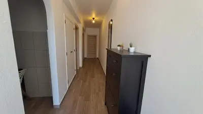 a hallway with a black dresser in a room at Albufeira Oura Beach Apartment in Albufeira