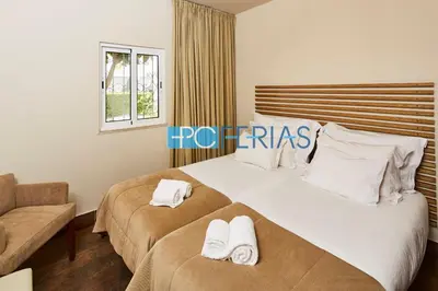 a bedroom with a large bed with towels on it at Apartamento em Albufeira a 10 min da praia * 50070/AL in Albufeira