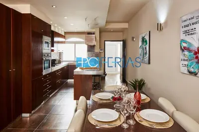 a kitchen with a table with plates and wine glasses at Apartamento em Albufeira a 10 min da praia * 50070/AL in Albufeira