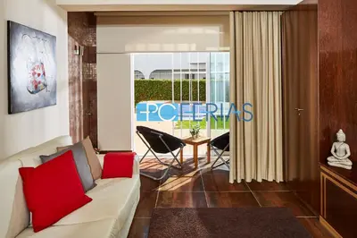 a living room with a white couch and red pillows at Apartamento em Albufeira a 10 min da praia * 50070/AL in Albufeira
