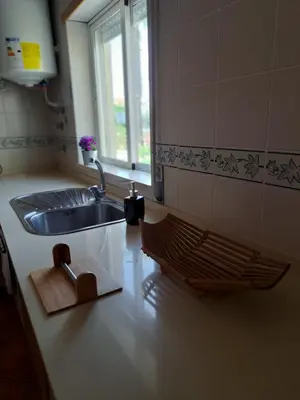 a kitchen with a sink and a wooden cutting board at Flat Caballero in Guia