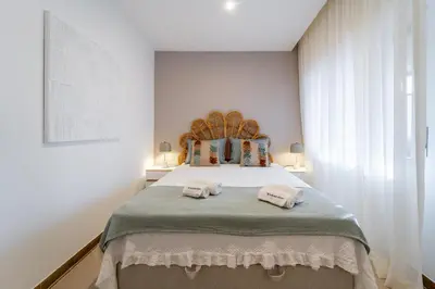 a bedroom with a bed with two towels on it at Palmeiras Apartment - 19A by HelloVacations in Albufeira