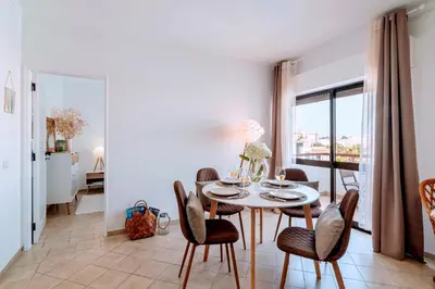 a dining room with a table and chairs at Holiday 1 Bed Apartment with pool in Albufeira in Albufeira
