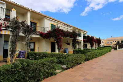 a building with flowers on the side of it at Vilamoura MiraGolf With Pool by Homing in Vilamoura