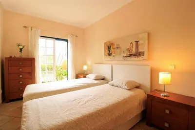a bedroom with two beds and a window at Vilamoura MiraGolf With Pool by Homing in Vilamoura