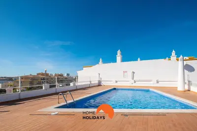 a swimming pool on the roof of a building at #075 T1 Solar by Home Holidays in Albufeira