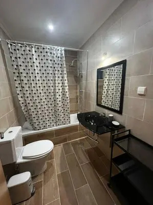 a bathroom with a toilet and a sink and a shower at Quinta Vita- Vila Laranja in Almancil