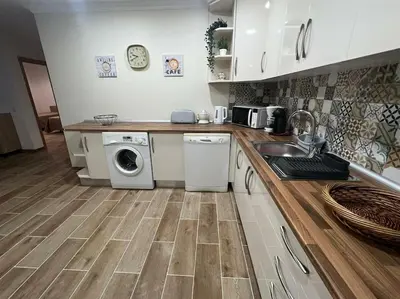 a kitchen with a sink and a washing machine at Quinta Vita- Vila Laranja in Almancil