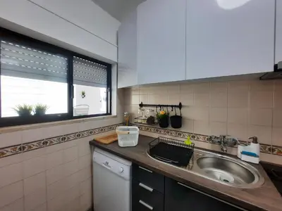 a small kitchen with a sink and a window at Casa Cerro Sol in Albufeira