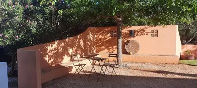 a table and chairs sitting under a tree at Rural Peace in the Algarve - Private Room with kitchenette and bathroom in Aldeia dos Matos