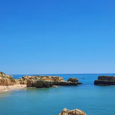 a view of a beach with rocks in the water at Rural Peace in the Algarve - Private Room with kitchenette and bathroom in Aldeia dos Matos