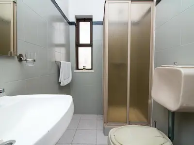 a bathroom with a shower and a toilet and a sink at Villa Bel Mar by Stay ici Algarve Holiday Rental in Guia