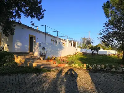 a shadow of a person in front of a house at Quinta do Amendoal o melhor da Natureza no Algarve in Terras Novas