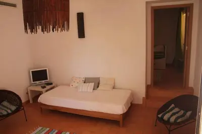 a small bedroom with a bed and a television at Quinta do Amendoal o melhor da Natureza no Algarve in Terras Novas