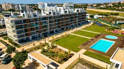 an aerial view of a building with a swimming pool at Apartamento Vista Jardim by Portucasa in Albufeira