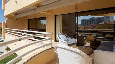 a balcony with wicker chairs and a view of the city at Marina 2BDR Apartment With Balcony & Pool - 5min from beach by LovelyStay in Quarteira