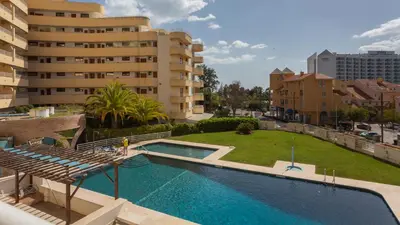 a view of a swimming pool in front of a building at Marina 2BDR Apartment With Balcony & Pool - 5min from beach by LovelyStay in Quarteira