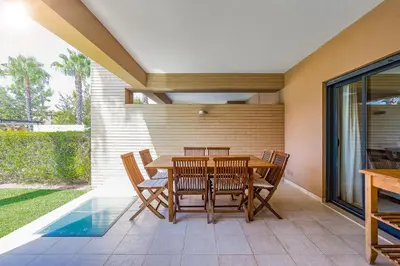 a dining room with a table and chairs at Apartamento Janelas Oceano - Vilamoura in Quarteira