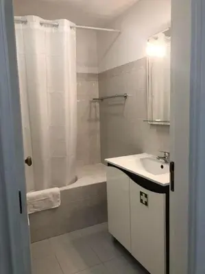 a bathroom with a shower and a sink and a tub at Bmar in Quarteira
