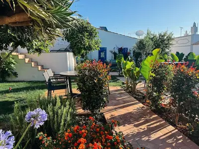 a garden with a table and chairs and flowers at Old Fisherman's Corner 14 - Centro Old Town Albufeira in Albufeira