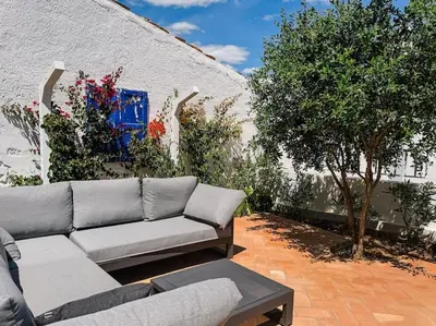 a couch sitting on a patio next to a building at Old Fisherman's Corner 10 - Centro Old Town Albufeira in Albufeira