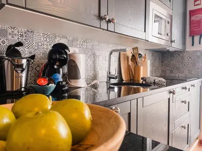 a kitchen with a bowl of fruit on a counter at Old Fisherman's Corner 12 - Centro Old Town Albufeira in Albufeira