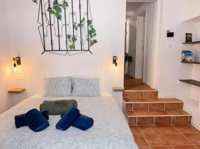 a bedroom with a bed with blue pillows on it at Old Fisherman's Corner 12 - Centro Old Town Albufeira in Albufeira
