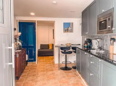 a kitchen with a counter and a table in a room at Old Fisherman's Corner 12 - Centro Old Town Albufeira in Albufeira