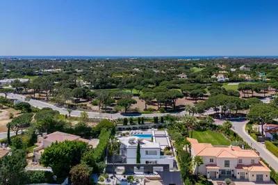 an aerial view of a resort with a pool and houses at Villa Allegra - Quinta do Lago in Almancil