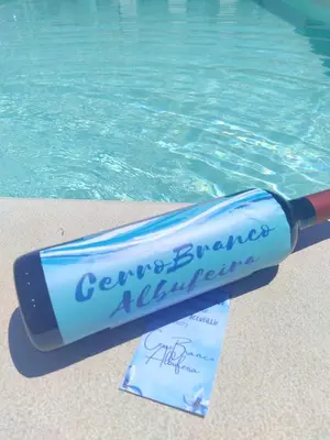 a message in a bottle next to a swimming pool at Luxurious Seaview Apartment with pool 5min Beach in Albufeira