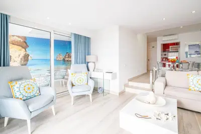 a living room with a view of the ocean at Luxurious Seaview Apartment with pool 5min Beach in Albufeira