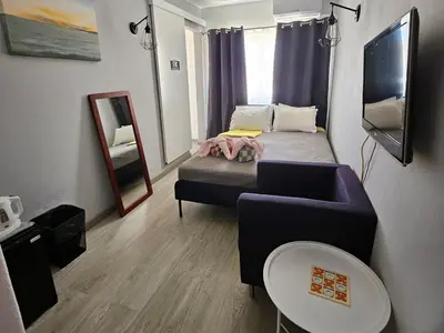 a small room with a bed and a couch at Guest House Casa Ramos on the Strip in Albufeira