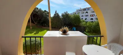 a balcony with a window with a potted plant on a table at CASA IRINA Centro Cidade Albufeira in Albufeira