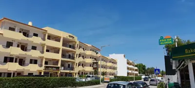 a building on a street with cars parked in front of it at CASA IRINA Centro Cidade Albufeira in Albufeira