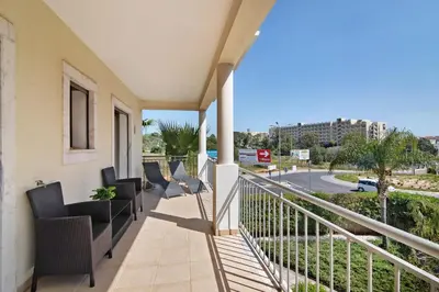 a balcony with chairs and a view of a street at Varandas do Sol - Olhos de Água in Albufeira