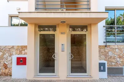 a bedroom with a bed and a large window at BnB Homes Ocean view Apartment with panoramic Terrace, 2 Swimming pools & Tennis court in Albufeira