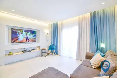 a living room with a couch and a flat screen tv at Vale Mangude A by MTPhomes in Albufeira
