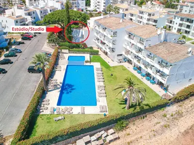 a dining room with a white table and chairs at Estúdio Solar A by MTPhomes in Albufeira