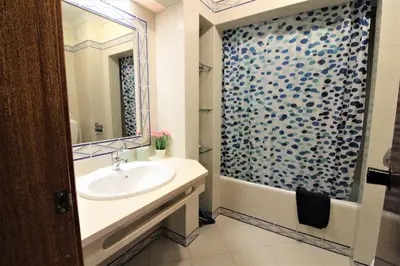 a bathroom with a sink and a shower at Centre City - Albufeira in Albufeira