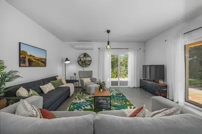 a living room with couches and a tv at Stunning Countryside Villa w Private Garden & Pool in Alte