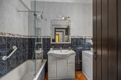 a bathroom with a sink and a tub and a mirror at Stunning Countryside Villa w Private Garden & Pool in Alte