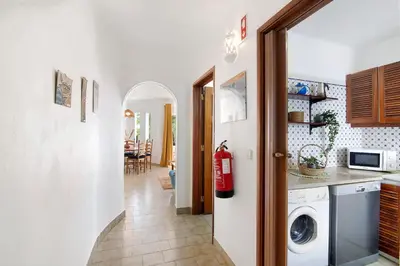 a kitchen with a washer and dryer in a room at Apartamento São Rafael in Albufeira